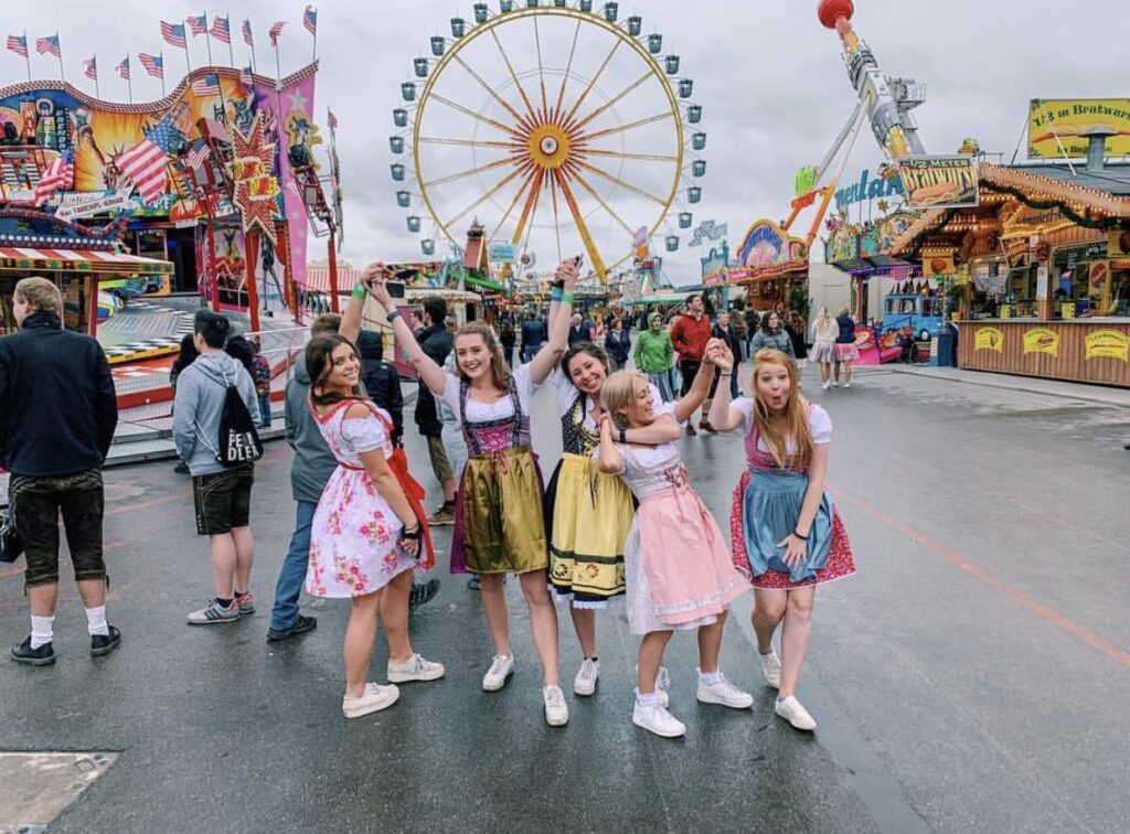 group of young women wearing different dirndl designs at Oktoberfest.