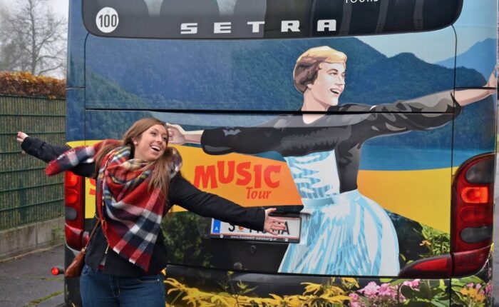 Girl in front of a Sound of Music tour bus in Salzburg