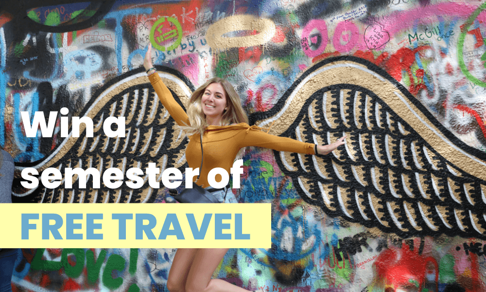 Girl in front of angel wings on Lennon wall on Bus2alps Prague and Munich trip.